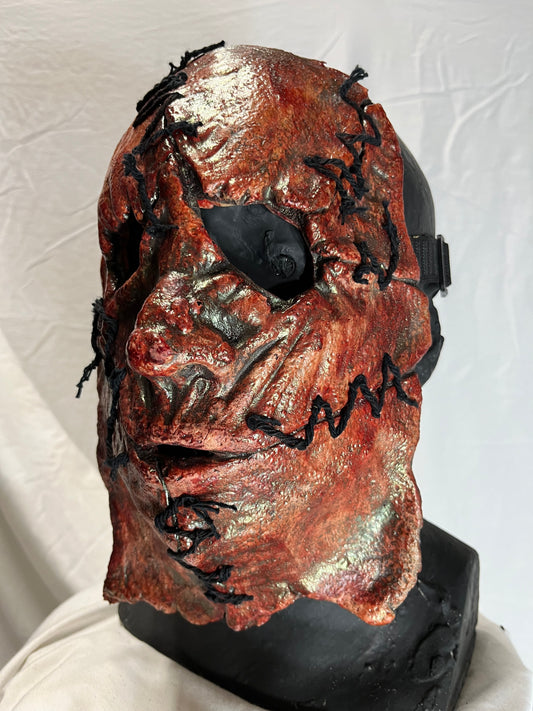Bloody skinned face mask with stitches